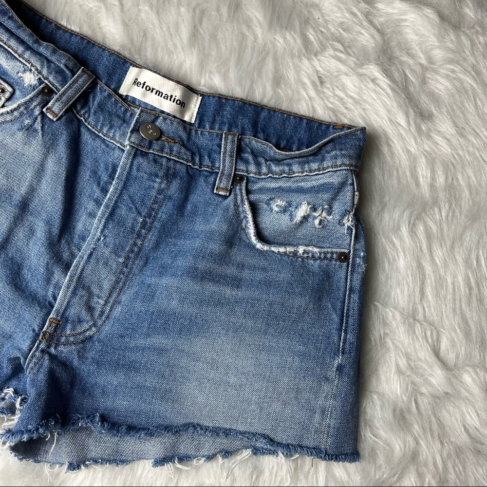 Reformation | Distressed Raw Hem Mid Wash Denim High Rise Jean Shorts 26